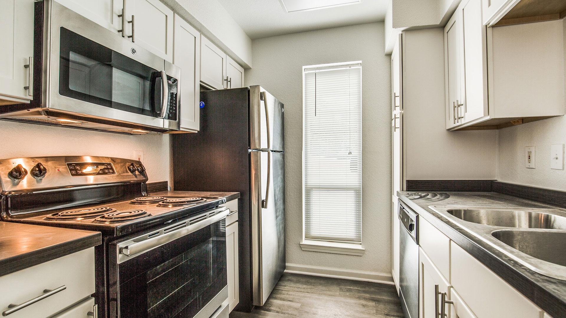 a kitchen with stainless steel appliances and a microwave at The WESTON