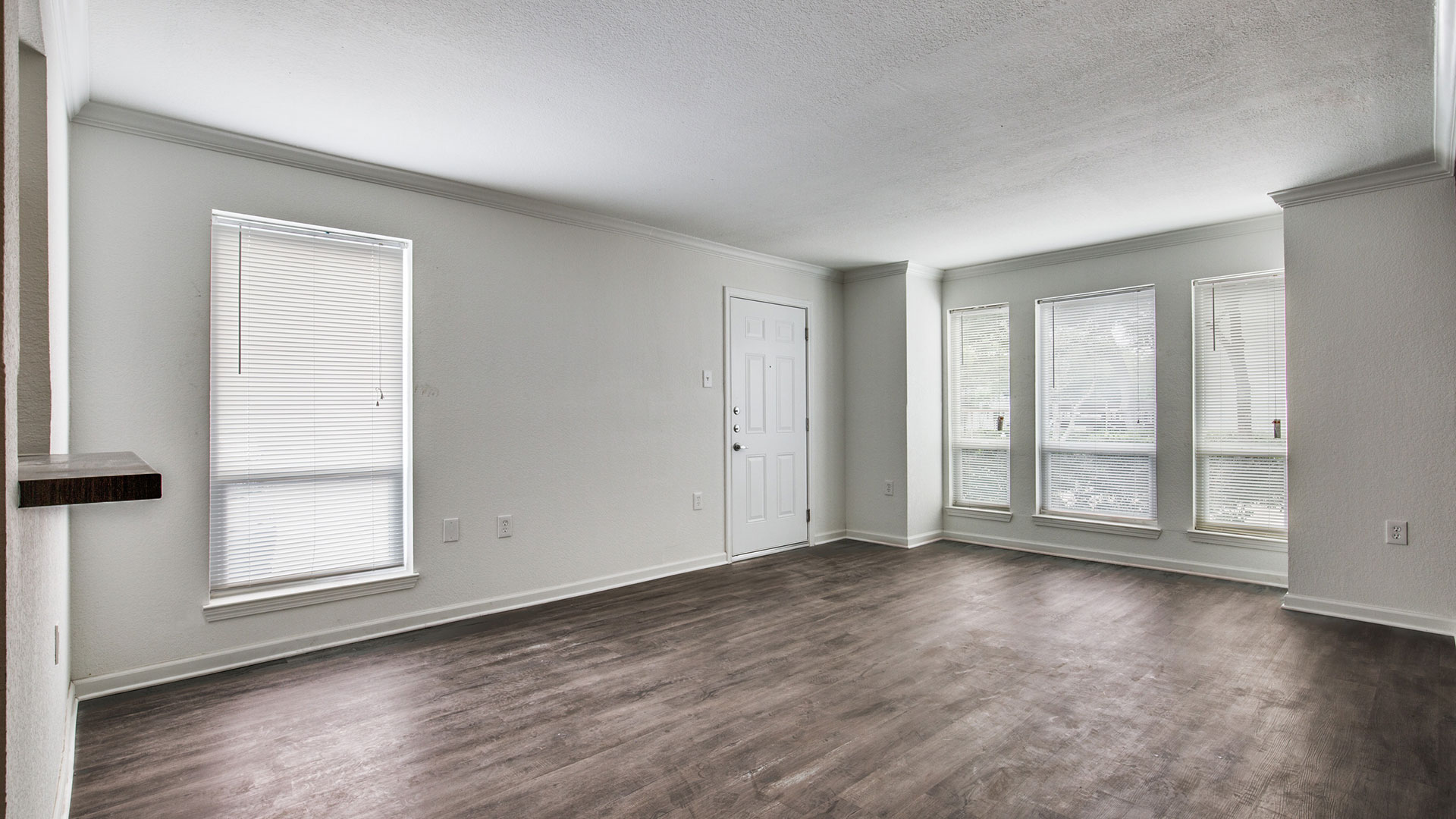 empty room with hardwood floors and windows at The WESTON