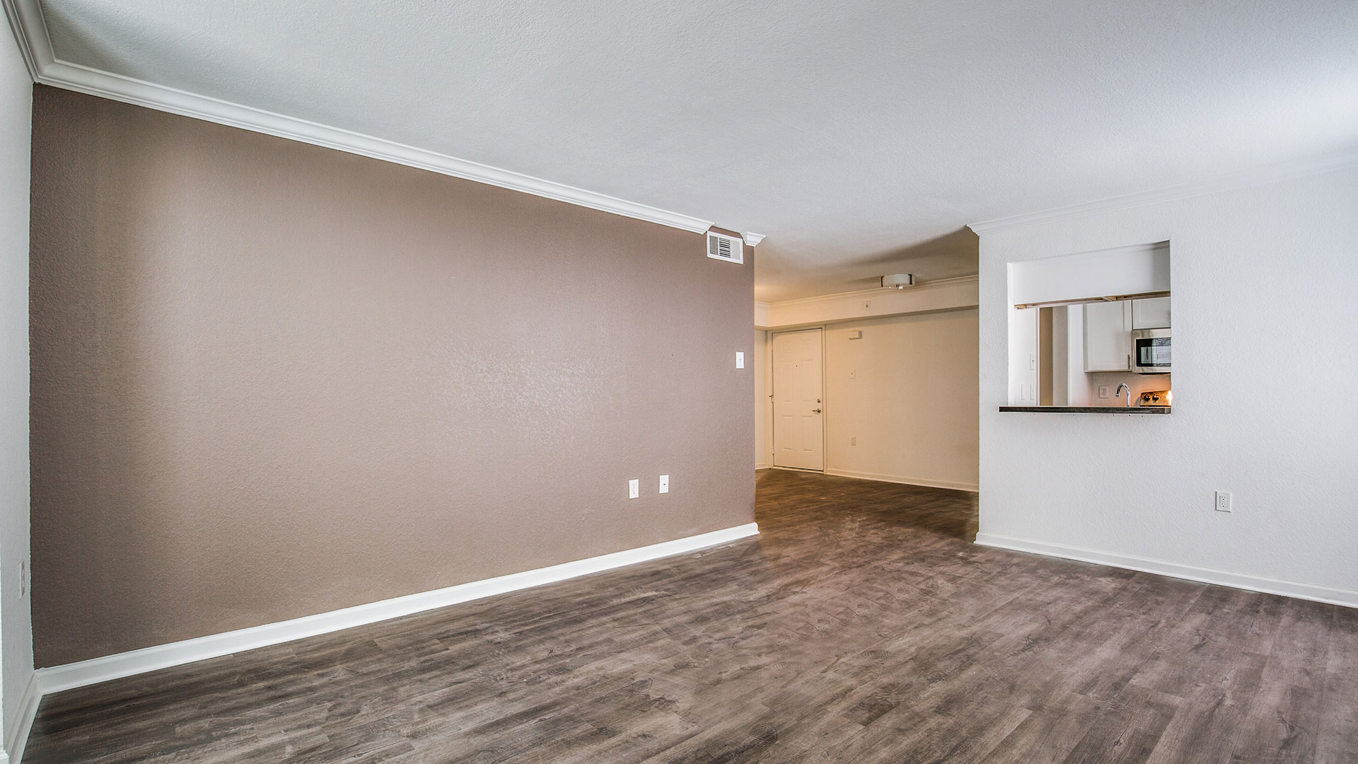 empty room with hardwood floors and brown walls at The WESTON