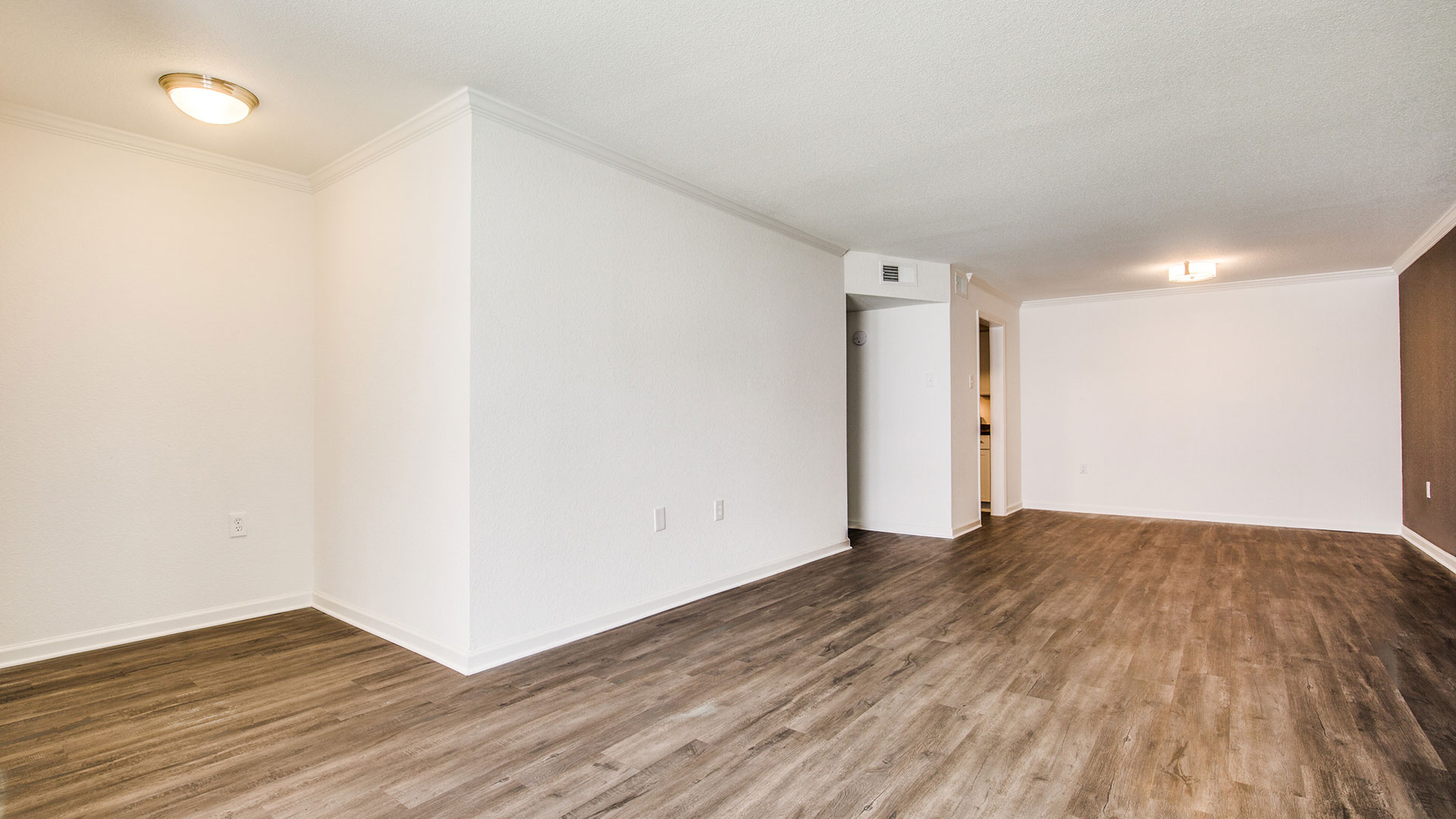 empty room with hardwood floors and white walls at The WESTON