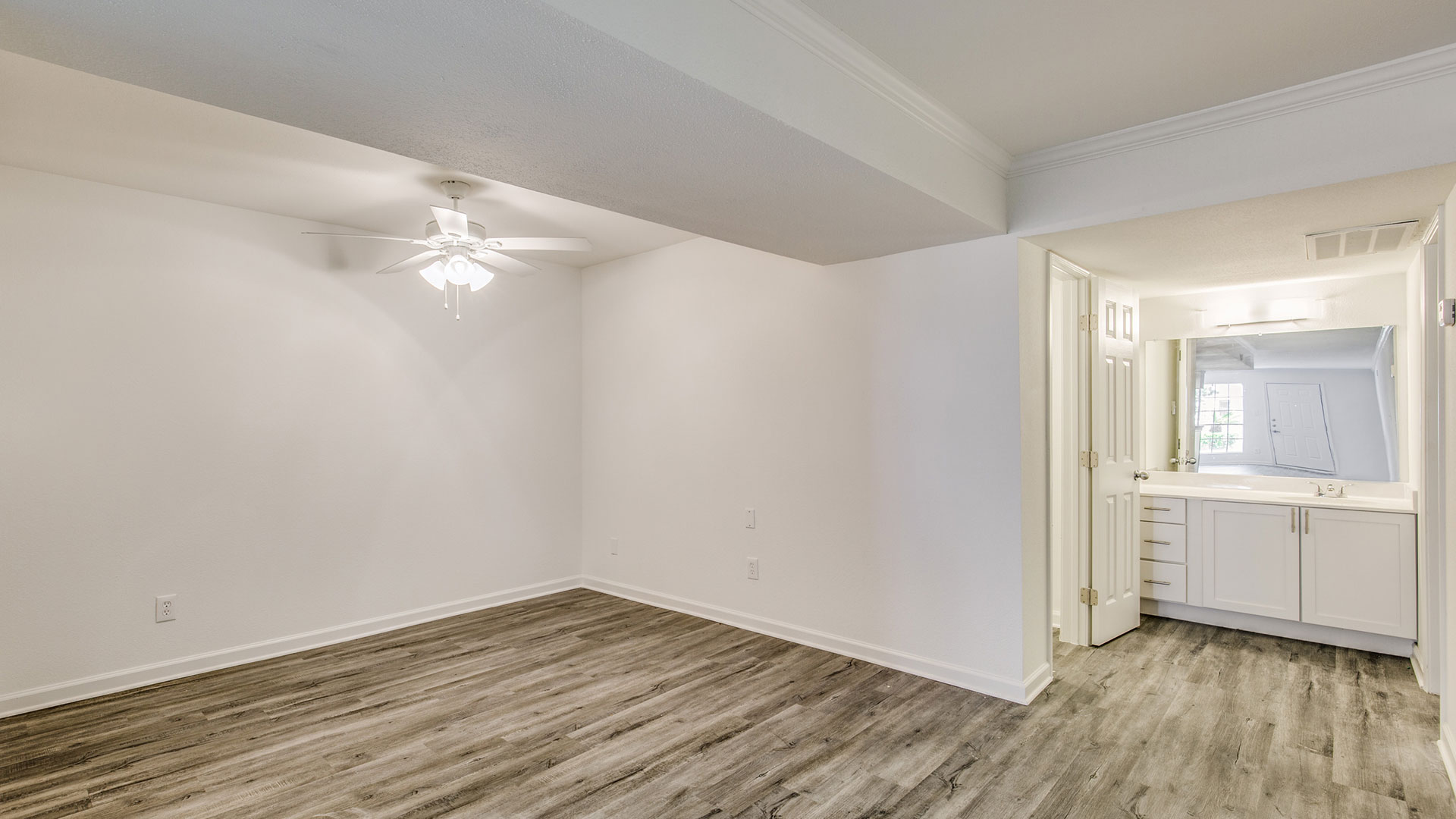 empty room with white walls and hardwood floors at The WESTON