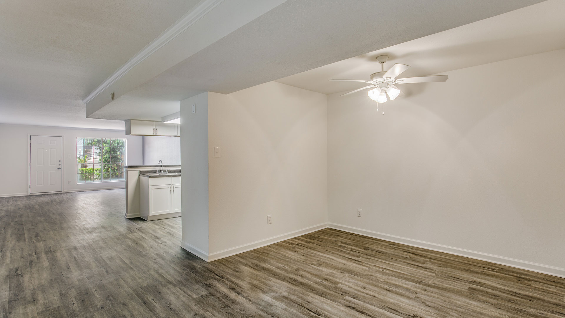 empty room with hardwood floors and ceiling fan at The WESTON