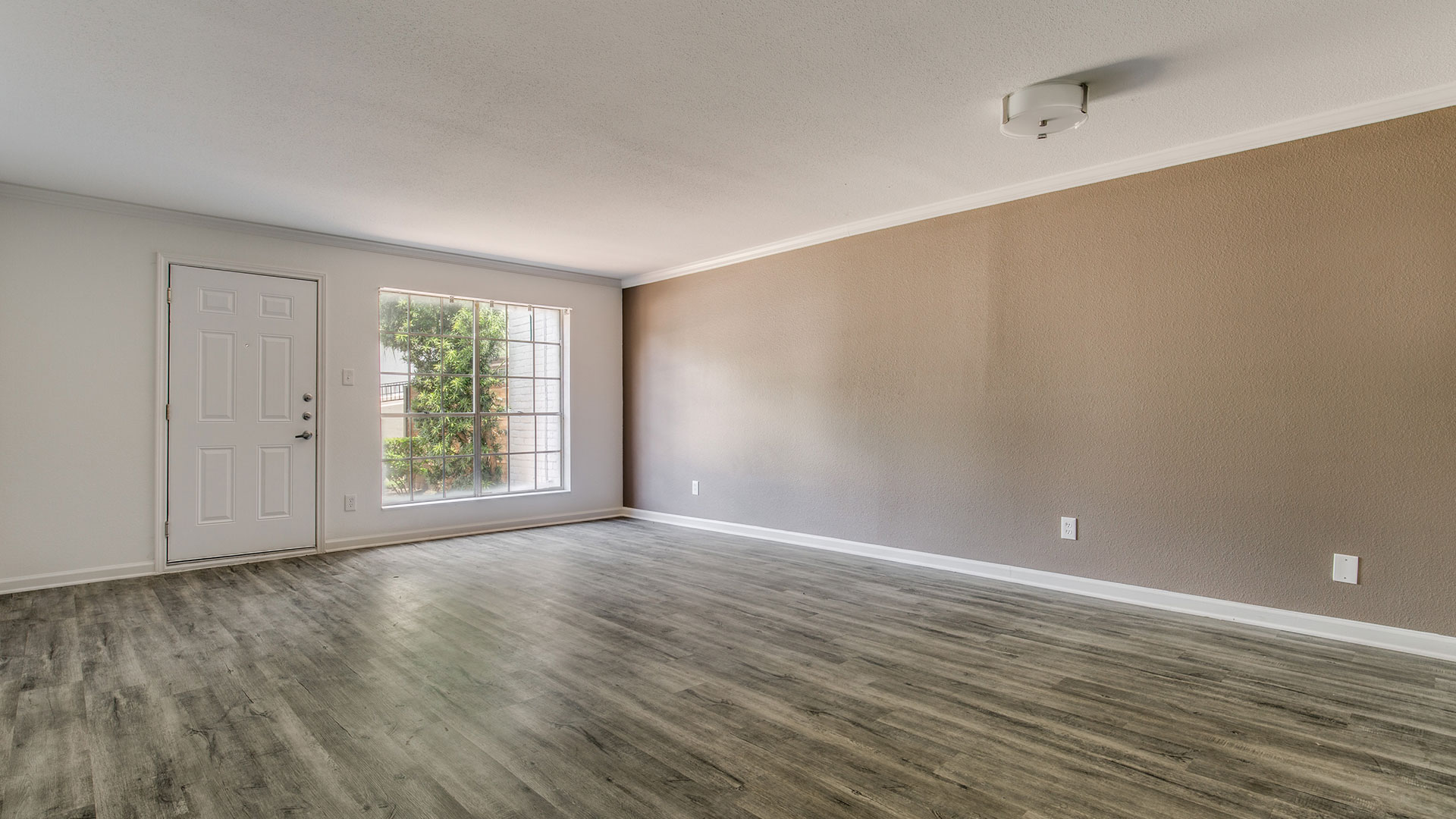 empty room with hardwood floors and light brown walls at The WESTON