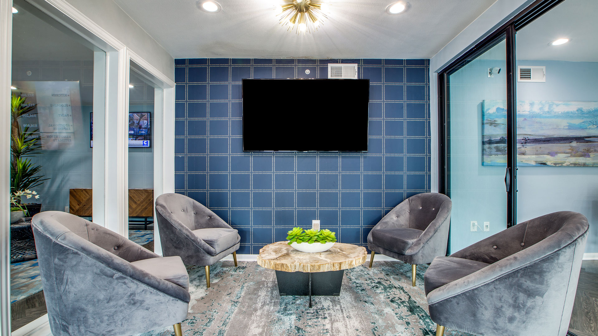 the living room features blue walls and a flat screen tv at The WESTON