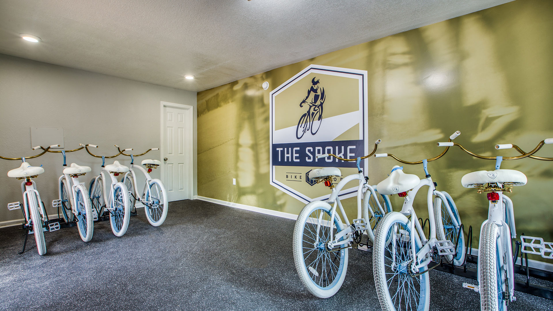 a room with bicycles and a sign that says the crest at The WESTON
