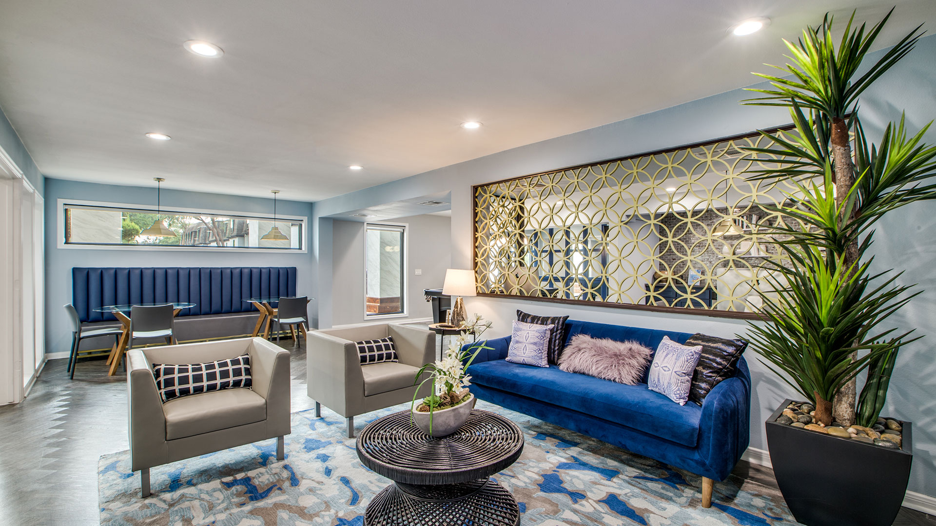 a living room with blue couches and a blue rug at The WESTON