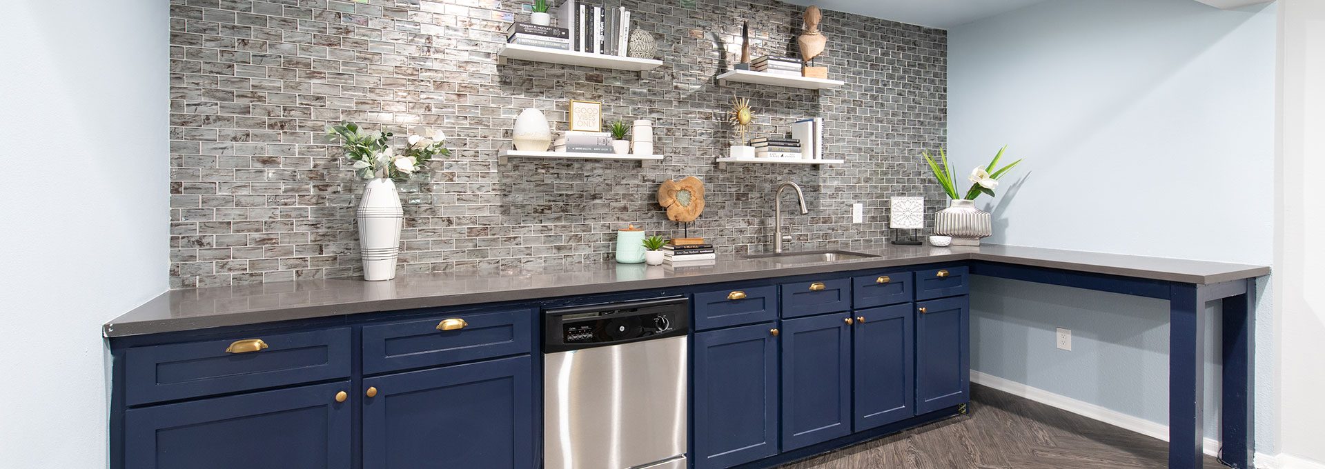 a kitchen with blue cabinets and a white counter at The WESTON