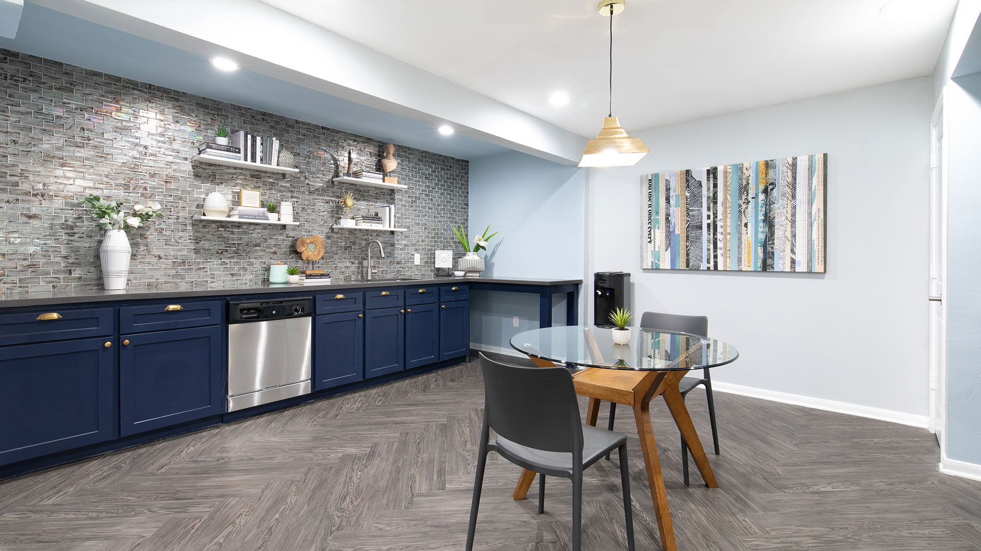 a kitchen with blue cabinets and a dining area at The WESTON