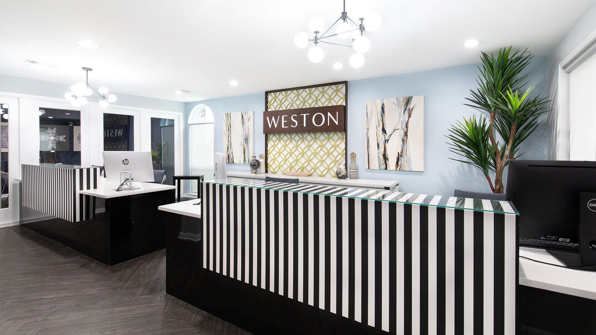 a reception area with a black and white striped wall at The WESTON