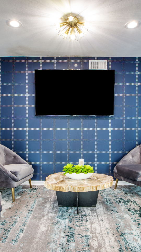 the living room features blue walls and a flat screen tv at The WESTON