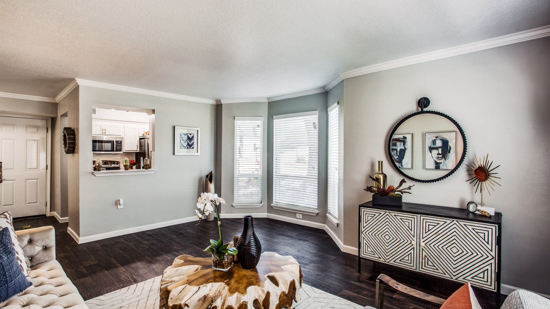 a living room with hardwood floors and a large window at The WESTON