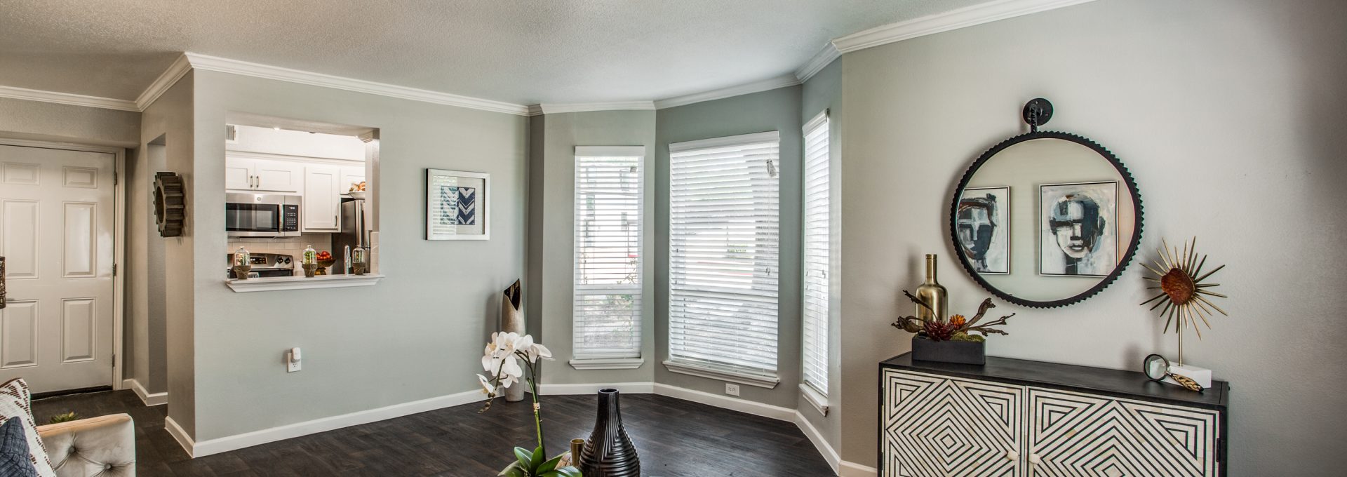 a living room with hardwood floors and a large window at The WESTON