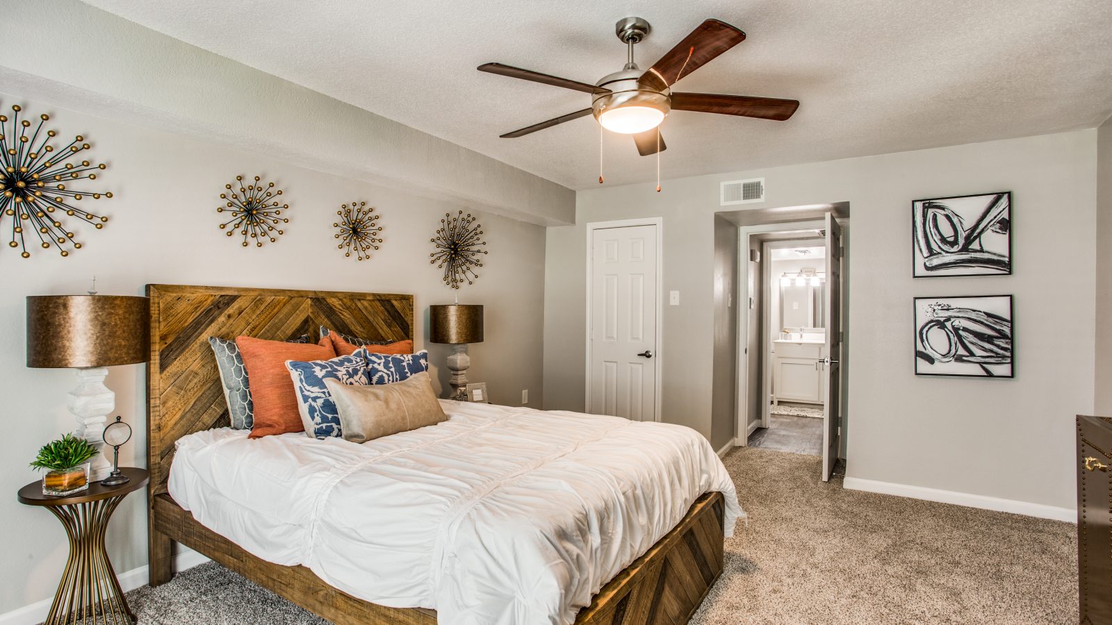 a bedroom with a ceiling fan and a bed at The WESTON